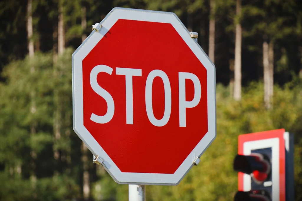 Red stop sign by the road